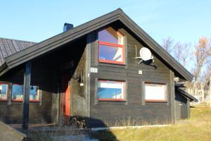 ein Haus mit roten Fenstern und Sat-TV in der Unterkunft Lev-Vel - 10 person cabin in Ål