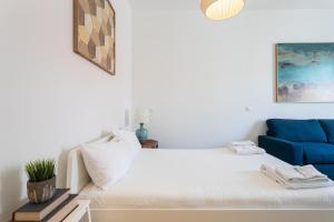 a bedroom with a white bed and white walls at FLH Restauradores Modern Studios in Lisbon