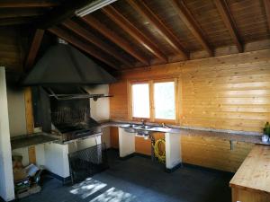 a large kitchen with a stove and a sink at Borda Cortals de Sispony in La Massana
