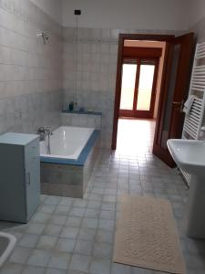 a bathroom with a tub and a sink at B&B Porta del Gargano in San Marco in Lamis