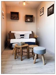 a living room with a couch and a table at -CAPCIR- Standing, cosy, 50m de la plage, parking, wifi in Canet-en-Roussillon