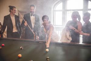 a group of people standing around a pool table at Bjertorp Slott in Kvänum