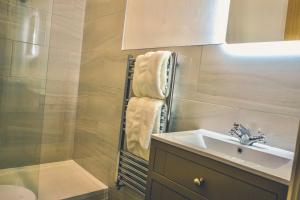 a bathroom with a sink and a shower at Shard Riverside in Poulton le Fylde