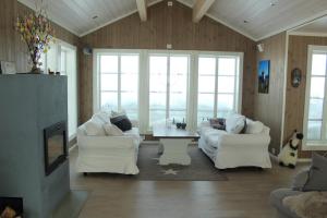 a living room with two white couches and a table at Torshaug 4 bedroom cabin in Gol