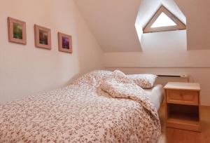 a bedroom with a bed with a blanket on it at Vila Idila in Lendava