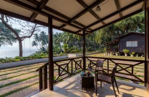 a view of the ocean from the porch of a house at SaffronStays Little Paradise, Murud in Murud