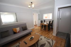 a living room with a couch and a table at The Uxbridge House in Uxbridge