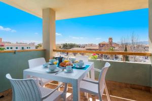 a white table and chairs on a balcony with a view at Apartamento Bressol D in Port de Pollensa