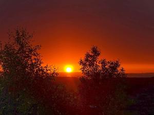 a sunset with the sun setting in the distance at 6 person holiday home in Kvalsund in Repparfjord