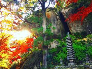 a painting of an autumn forest with a pagoda at Guesthouse Kimiko in Kasagicho