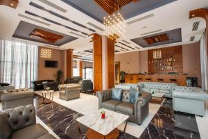 a lobby with couches and chairs and a bar at Horizont Hotel Tbilisi in Tbilisi City