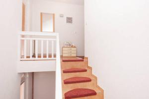 a stairway with red cushioned cushions on the stairs at Guesthouse Relax and Fly Sarajevo in Sarajevo