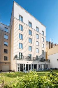 a large white building with a balcony at Three Corners Lifestyle Hotel in Budapest