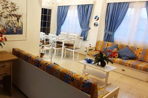 a living room with a couch and a table at EasyStay Two Bedroom Apartment in Larnaka