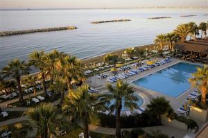 an aerial view of a resort with a pool and palm trees at EasyStay Two Bedroom Apartment in Larnaka