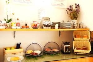 a shelf with plates and food on it at Hotel Franklin Feel The Sound in Rome