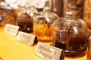 a table with several jars of honey on it at Hotel Franklin Feel The Sound in Rome