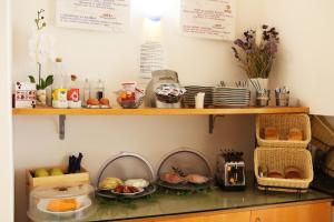 a counter with plates of food on a shelf at Hotel Franklin Feel The Sound in Rome