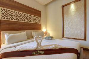 Tempat tidur dalam kamar di Hotel Prince Gardens