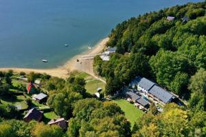 an aerial view of a house on a hill by the water at Hotel Zátoka in Holčíkovce