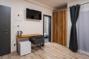 a room with a desk and a television on the wall at Penzión Imperial in Žarnovica