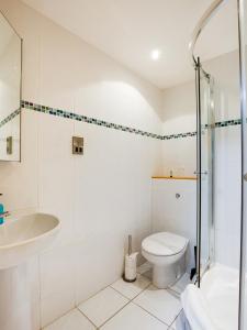 a bathroom with a shower toilet and a sink at Auld Mill House Hotel in Dunfermline