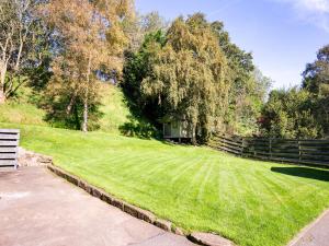 a large grassy field with a house in the background at Auld Mill House Hotel in Dunfermline