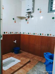 a bathroom being remodeled with a toilet and a camera at Freshup & Stay in Chikmagalūr