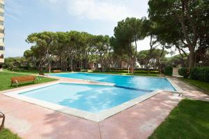 a swimming pool in a yard with trees at Pine Paradise by Seasidehomes in Gavà