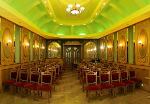 a conference room with a bunch of chairs and a chandelier at Hotel Star in Mukacheve