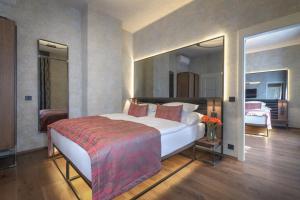 a bedroom with a large white bed in a room at Hotel Waldstein in Prague