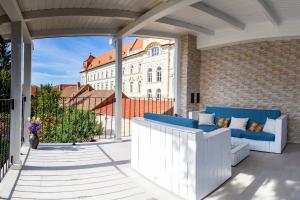 a patio with blue and white furniture and a building at Casa Schubert3 in Oradea