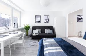 a living room with a couch and a table at Warsawrent Apartamenty Centralna in Warsaw