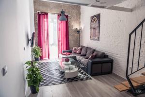 a living room with a couch and a table at GoToSeville FERIA APARTMENTS in Seville