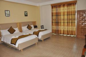 Postel nebo postele na pokoji v ubytování Mekelle Hotel