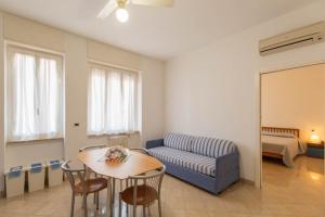 a living room filled with furniture and a table at Residenza Adelaide in Finale Ligure