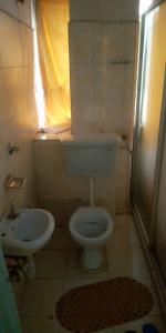 a small bathroom with a toilet and a sink at Hotel Jaffers Nairobi in Nairobi