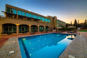 a large swimming pool in front of a building at Century Park Hotel in Amman