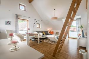 a living room with a staircase leading to a living room at Apartmenthaus am Erlbach in Buch am Erlbach