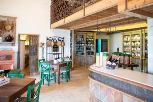 a restaurant with a bar and tables and chairs at Tenuta Saiano Resort in Torriana