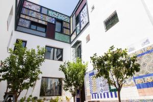 a building with mosaics on the side of it at HOTEL TRIANA MONTALVAN in Seville