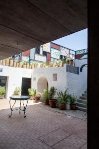 a patio with a table and potted plants on a building at HOTEL TRIANA MONTALVAN in Seville