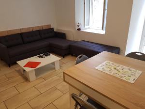 a living room with a couch and a table at Lourdes Guest House in Lourdes