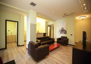 a living room with two couches and a television at Chalkida Seafront Apartment in Chalkida