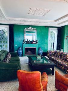 a living room with a couch and a fireplace at Villa Dar Jbila Tanger in Tangier