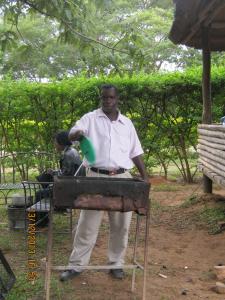 a man holding a green item in a machine at Lochinvar Safari Lodge of Lochinvar National Park - ZAMBIA in Lochinvar National Park