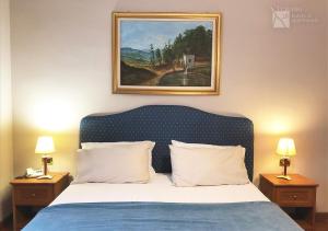 a bedroom with a bed with a painting on the wall at Traiano 28 in Turin