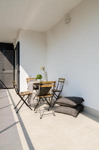 a dining room with a table and chairs at FCO Luxury Apartments in Fiumicino