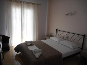 Postel nebo postele na pokoji v ubytování Anesis Hotel