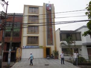eine Gruppe von Menschen steht vor einem Gebäude in der Unterkunft Aparta Hotel Plaza Real Norte in Cali